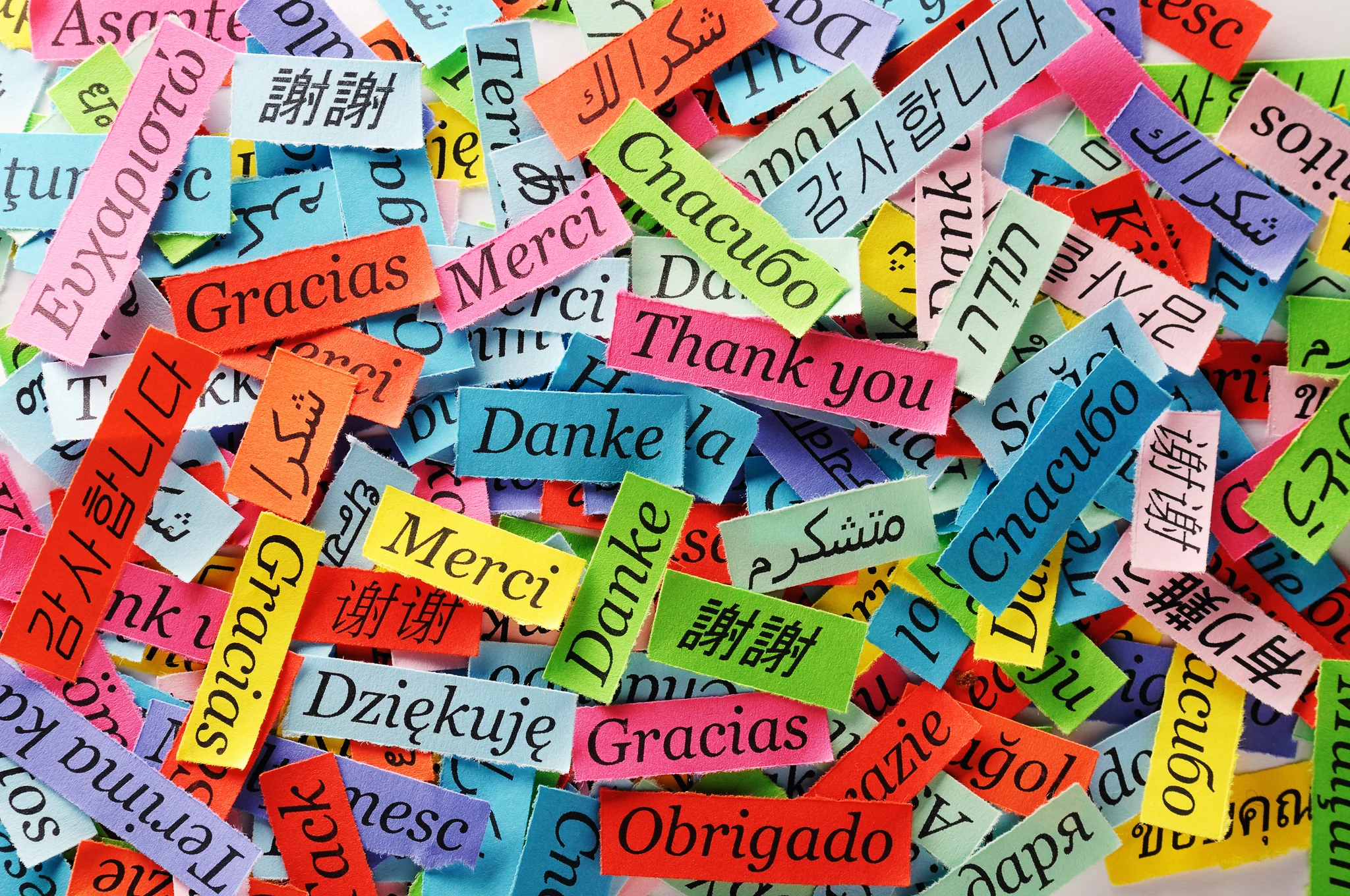 Thank you written on paper slips in many languages